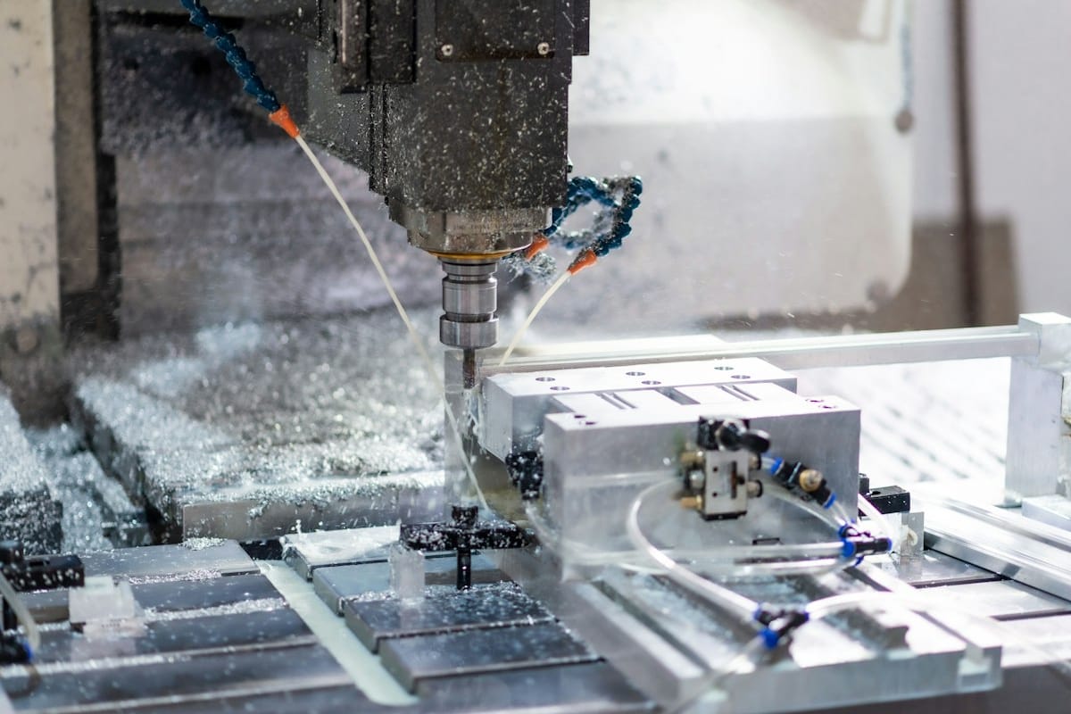 CNC milling machine cutting a metal part