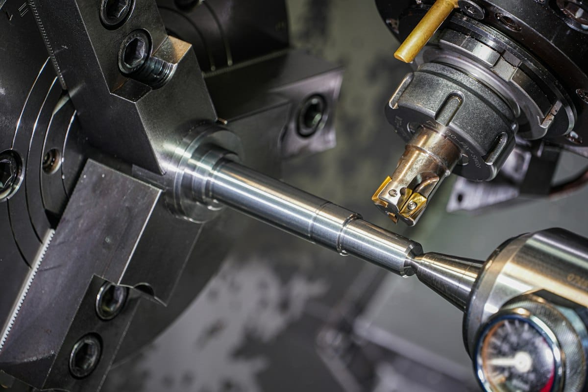 Metal rod being machined on a CNC lathe